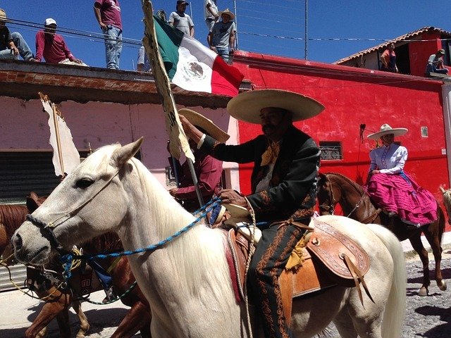Mexican horseman carrying the national flag during Independence Day celebration