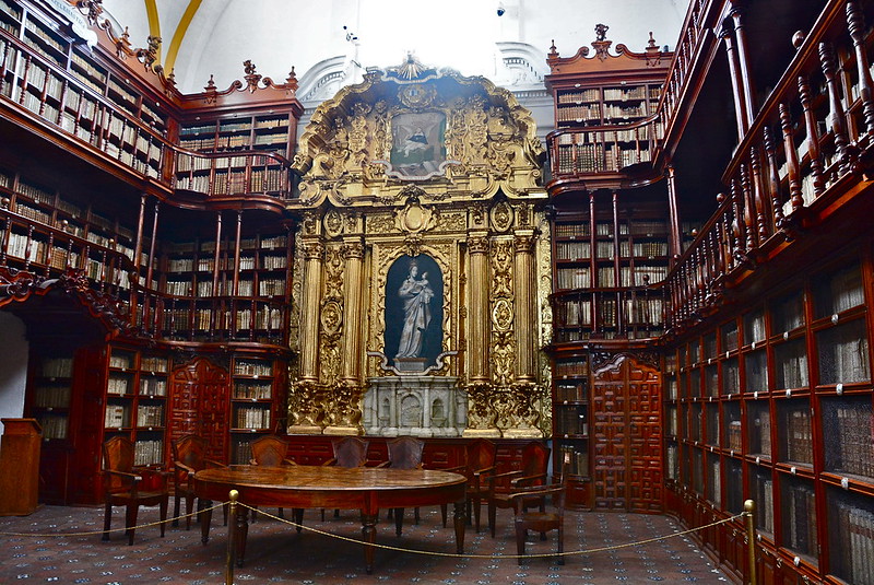 Historic Palafoxiana Library with ornate bookshelves and golden baroque details