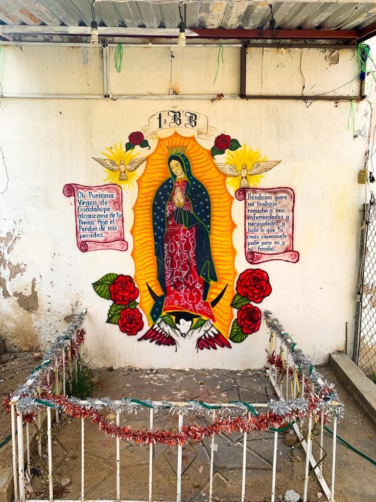 Vibrant Virgin of Guadalupe mural with traditional Mexican decorations