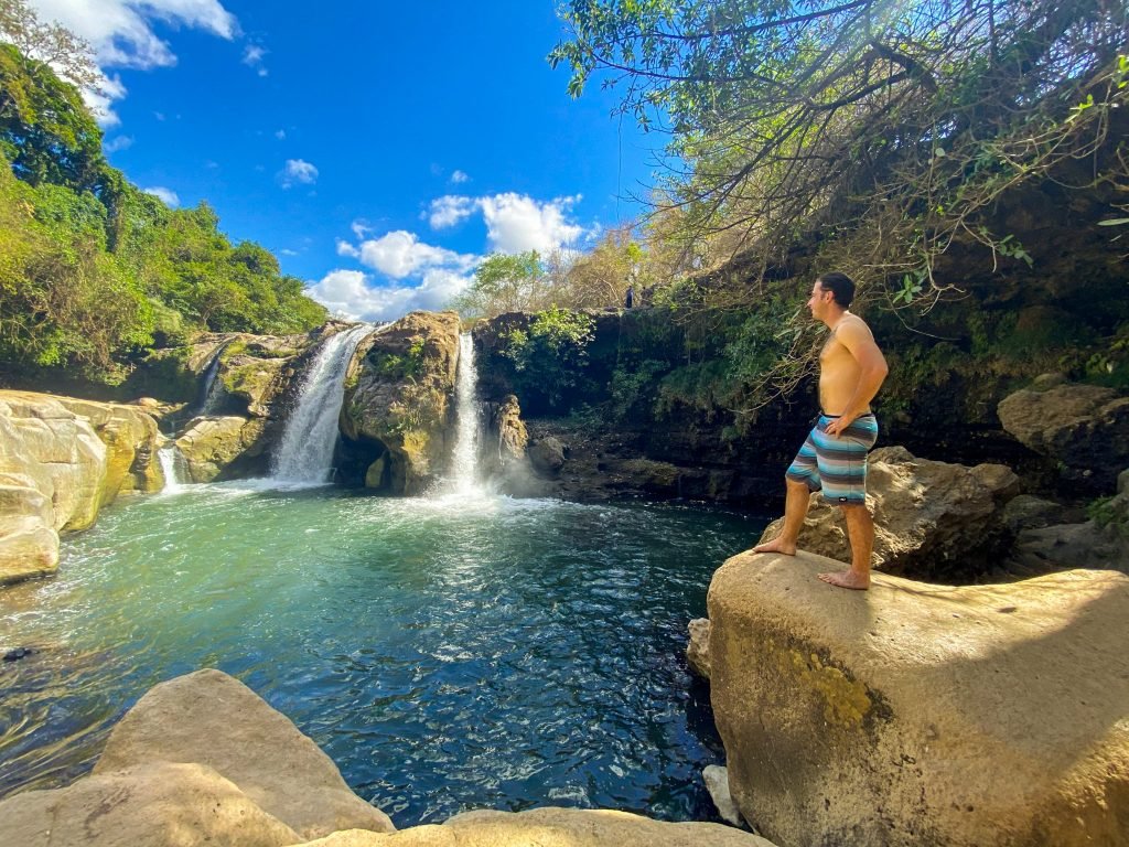 Natural hot spring waterfall in a lush tropical setting